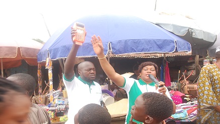 Mrs. Onajite Regha, (right) executive secretary and chief executive officer, E-PPAN, teaching traders on the use of the PoS in a market in Edo state during the sensitizationn exercise.